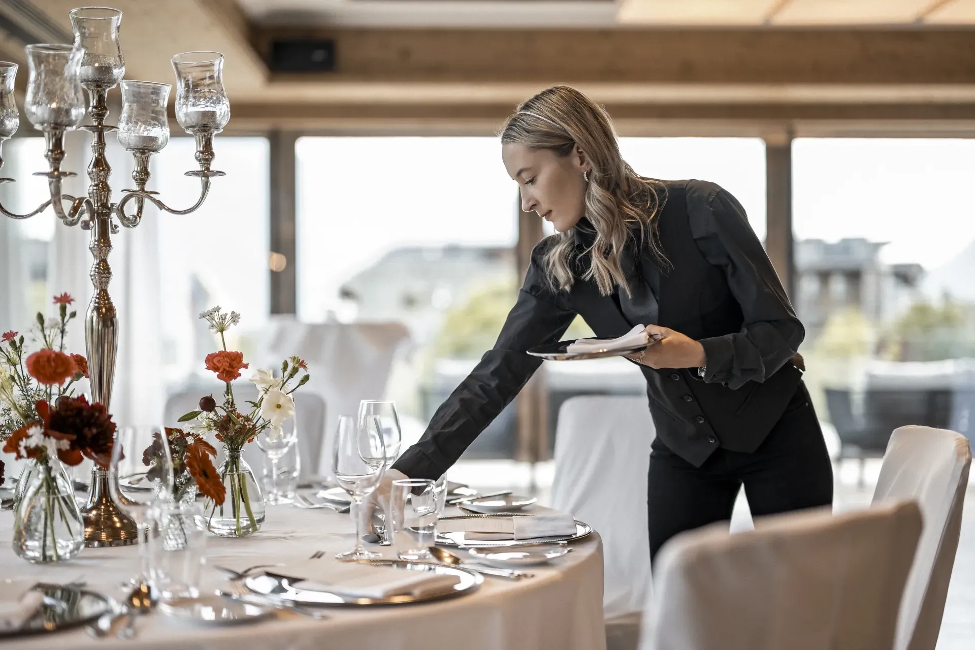 Final touches to the festively decorated wedding table at the Greenvieh